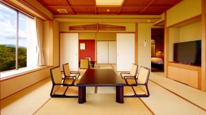 a conference room with a table and chairs at Jodogahama Park Hotel in Miyako