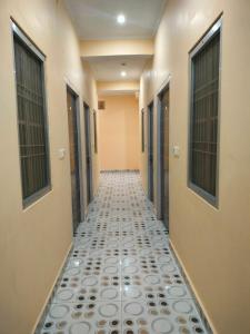 a hallway with a tile floor in a hallway at Hotel Dev Inn Ayodhya in Ayodhya