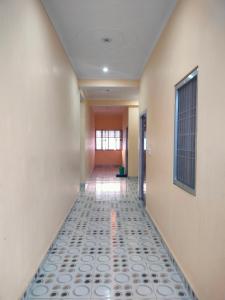 a hallway with a tile floor in an office building at Hotel Dev Inn Ayodhya in Ayodhya