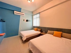 Uma cama ou camas num quarto em 澎湖樂在綺中民宿 第580號