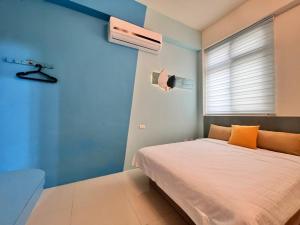 Uma cama ou camas num quarto em 澎湖樂在綺中民宿 第580號