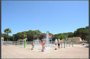 a playground with a bunch of water play equipment at Mobilhome 6personnes camping oasis village 5 etoiles in Puget-sur-Argens