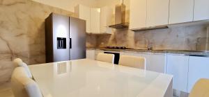 a kitchen with a white counter top and a sink at Farah’s house in Padova