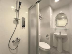 uma casa de banho com um chuveiro, um WC e um lavatório. em Chair Man Hotel em Taipei