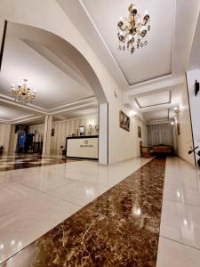 a large lobby with a marble floor and a chandelier at MariaLuis Hotel in Tbilisi City