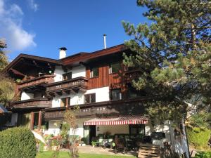 a house in the mountains with trees at Ferienhaus Pension Gulla in Neustift im Stubaital