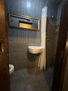 a bathroom with a sink and a mirror and a toilet at Bed Bangkok Hostel in Bangkok