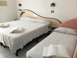 Postel nebo postele na pokoji v ubytování Hotel Rondinella