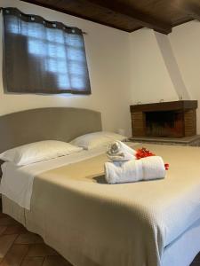 a bedroom with two beds with a towel on the bed at La CASETTA di Antonietta in Fiumicino