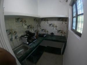 a bathroom with a sink and a counter top at Hobbit House Hostel in Rishīkesh