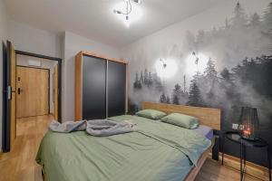 una camera da letto con un letto e un murale nel bosco. di Nowa 14a a Zielona Góra