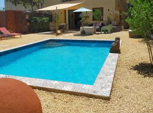 a swimming pool with blue water in a yard at Casa Francesca Altea piscina y aparcamiento privado in Altea