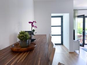 a dining room with a wooden table with a plant on it at Apartment Aria Velden in Velden am Wörthersee