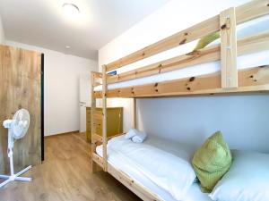 two bunk beds in a room with wooden floors at Apartment Aria Velden in Velden am Wörthersee