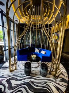 a living room with a blue couch and a wheel at STAR RESIDENCE KLCC in Kuala Lumpur