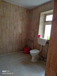 a bathroom with a toilet and a window at The Mir Villa Ladakh in Leh