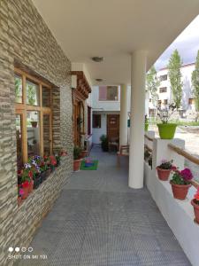 a hallway of a building with potted plants at The Mir Villa Ladakh in Leh