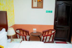 a room with a table and two chairs and a table at Best Lodge in Tamale