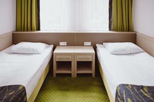 Postel nebo postele na pokoji v ubytování Arche Hotel Siedlce