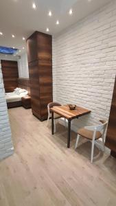 a room with a table and two chairs and a bed at Sky is the limit * Novi Sad * in Novi Sad