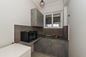Kuchyň nebo kuchyňský kout v ubytování Odysseas Studios + 21 fotografií