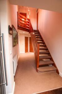 a winding staircase in a house with wooden railings at the bungalow in Oxford