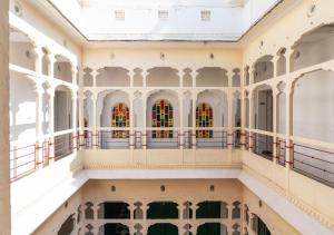 a building with stained glass windows and a balcony at Bloom Boutique - Chelon Haveli in Jaipur