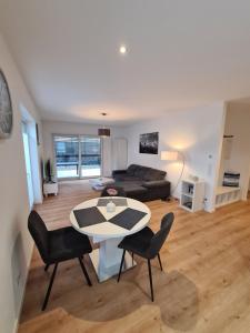 a living room with a table and chairs and a couch at Panorama Apartments in Füssen