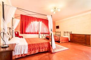 a bedroom with two beds with red curtains at B&B Villa Flora in Santeramo in Colle