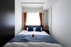 Ένα ή περισσότερα κρεβάτια σε δωμάτιο στο GLASS山鼻 EAST