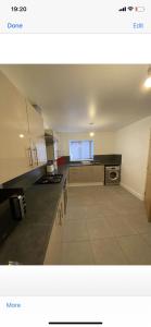 a large kitchen with a black counter top at Campion Place in Sheffield