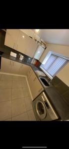 a kitchen with a washing machine and a window at Campion Place in Sheffield