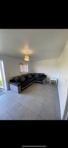 a living room with a black couch and a table at Campion Place Contractor Accommodation in Sheffield