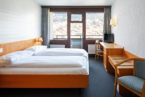 Postel nebo postele na pokoji v ubytování Jungfrau Lodge, Annex Crystal