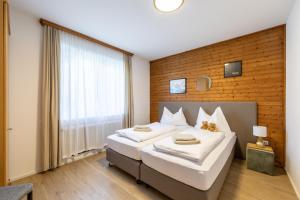 Łóżko lub łóżka w pokoju w obiekcie Appartements DAS RETTENBACHER