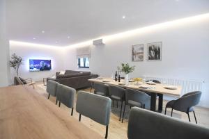 a dining room and living room with a table and chairs at VIlla Luka - new isolated villa with heated pool, jacuzi and sauna in Gračac