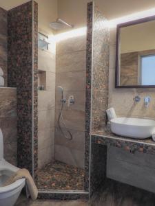 a bathroom with a shower and a sink at Spiti Marias by Thanos Village in Gialova
