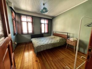 a bedroom with a bed and a table and windows at Dream House in Istanbul