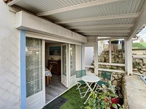 eine Terrasse mit einem Tisch und Stühlen auf einer Veranda in der Unterkunft Neptune in Royan