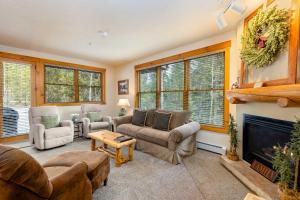 a living room with couches and a fireplace at 8782 Trappers Crossing Condo in Keystone