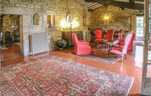a living room with red chairs and a table at Stunning Home In Cézac in Cézac