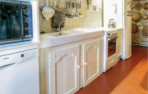 a kitchen with white cabinets and a sink at Stunning Home In Cézac in Cézac