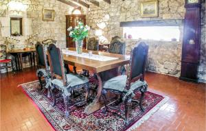 a dining room with a table and chairs on a rug at Stunning Home In Cézac in Cézac