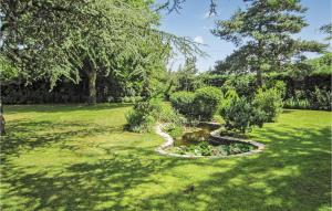 a garden with a pond in the grass at Stunning Home In Cézac in Cézac +15 photos