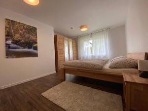 a bedroom with a large bed and a window at Schwarzwaldidyll in Todtmoos