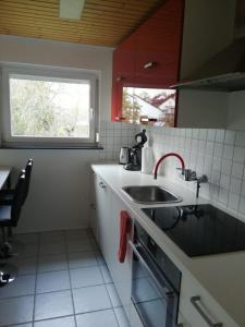 a small kitchen with a sink and a window at Haus Hochwald in Rottweil