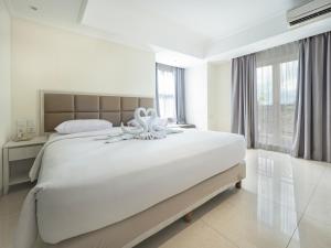 Postel nebo postele na pokoji v ubytování Alron Hotel Kuta