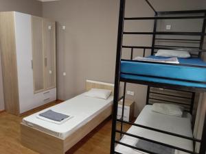 a room with two bunk beds and a ladder at Station Hostel in Atyrau