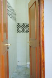 a bathroom with a toilet and a open door at Come to the Sea homestay Phú Yên in Tuy Hoa