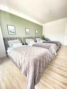 a bedroom with two beds in a room at RONI APARTMENTS -Near the historic city center -Family-friendly -Baby cots and toys available -Netflix -Convenient for sightseeing -Services available -Free parking with video surveillance in Prizren +27 photos